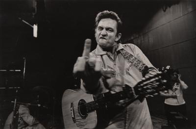 Lot #7215 Johnny Cash at San Quentin Oversized 'Middle Finger' Photograph Signed by Jim Marshall - From the Collection of Photographer Barry Feinstein - Image 1