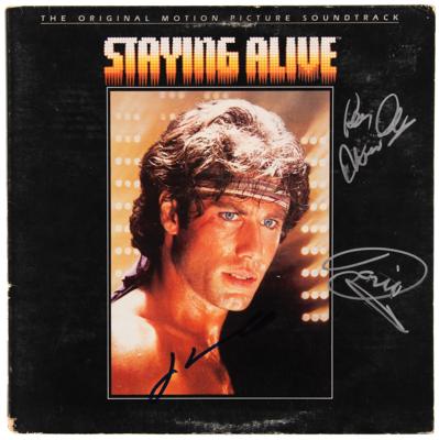 Lot #7323 The Bee Gees and John Travolta Signed Album - Staying Alive - Image 1