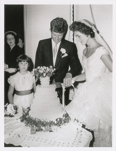 Lot #9184 John and Jacqueline Kennedy 1953 Wedding Photograph Cutting Cake - Image 1