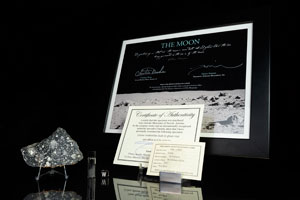 Lot #4003  NWA 11303 Lunar Meteorite Slice, Lunar Dust, and Charlie Duke Signed Photograph