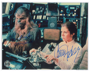 Lot #7549 Carrie Fisher and Peter Mayhew Signed Photograph - Image 1