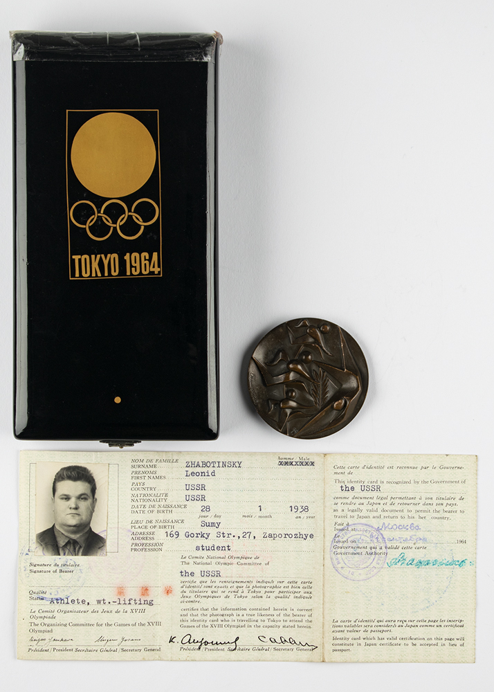 Lot #7081  Tokyo 1964 Summer Olympics ID Card, Participation Medal, and Gold Medal Case